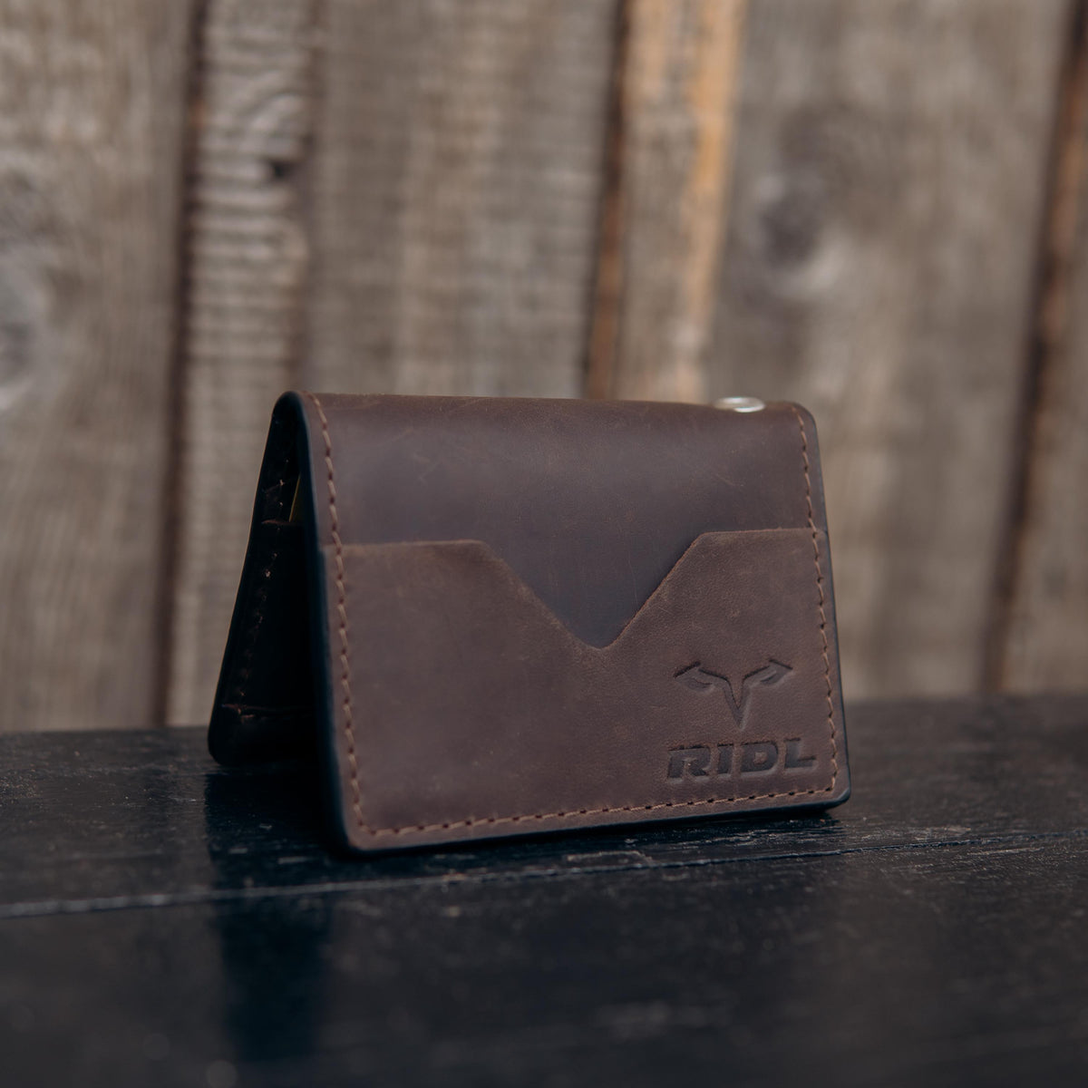 Handmade leather EDC wallet with magnetic closure, zip pocket and ID window by RIDL